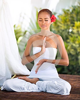 Beautiful woman practicing yoga outside