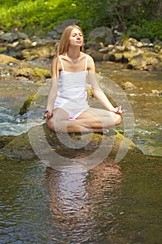 Beautiful Woman Practive Yoga On River In Nature