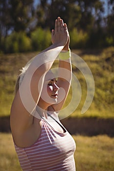 Beautiful woman praising yoga during obstacle course