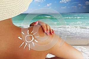 Beautiful woman preparing for sunbath, using sunscreen for a healthy sun protection of skin