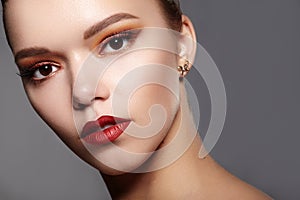Beautiful Woman with Professional Makeup. Party Gold Eye Make-up, Perfect Eyebrows, Shine Skin. Bright Fashion Look