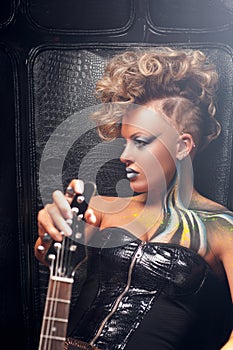 Beautiful woman punk with bass guitar profile