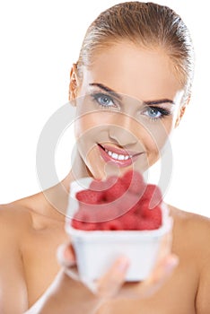 Beautiful woman with punnet of raspberries