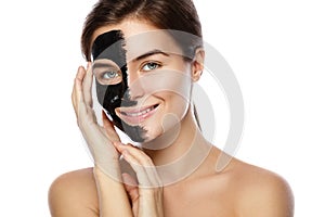 Beautiful woman with a purifying black mask on her face