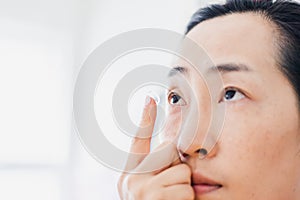 Beautiful Woman Putting Eye Lenses With Hands