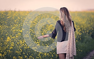 Beautiful woman in rapeseed field