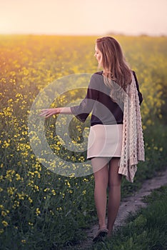 Beautiful woman in rapeseed field