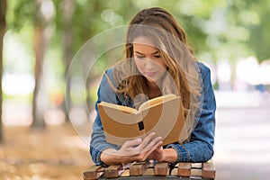 Beautiful woman read a book in the park