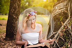 Beautiful woman reading a book in the park