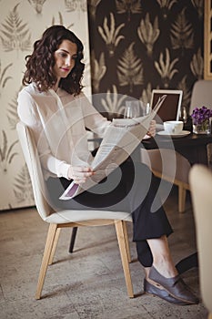 Beautiful woman reading newspaper