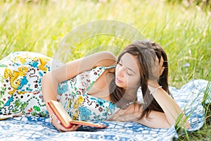 Beautiful woman reading outdoors