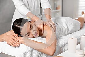 Beautiful woman receiving back massage in beauty salon, closeup