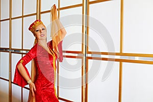 Beautiful woman in red Andalusian costume poses