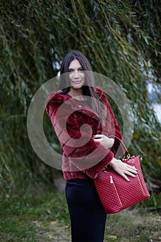 Beautiful woman with red coat and bag