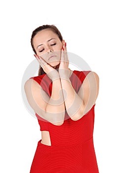 Beautiful woman in red dress with hands on face and closed eyes