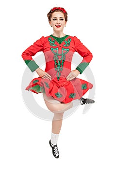 Beautiful woman in red dress for Irish dance jumping isolated