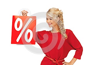 Beautiful woman in red dress with shopping bag