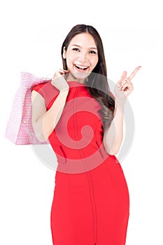 A beautiful woman in a red dress Showing a happy expression On a white background, A lovely woman holding a shopping bag and point