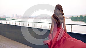 Beautiful woman in red fluttering dress.