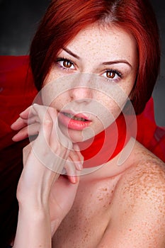 Beautiful woman with red hair and freckles