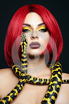 Beautiful woman with red hair and a yellow python snake around her neck. Professional Bright Beauty Eye Makeup Yellow, Red