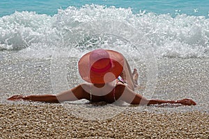 A beautiful woman with a red hat in the sea of Porto Katsiki, Lefkas