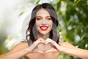 Beautiful woman with red lipstick and hand heart