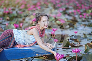 Beautiful woman with the red lotus sea