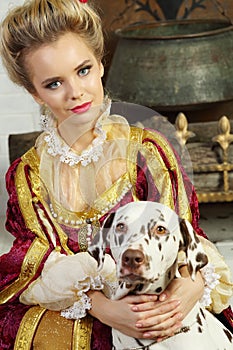 Beautiful woman in red medieval costume sits with