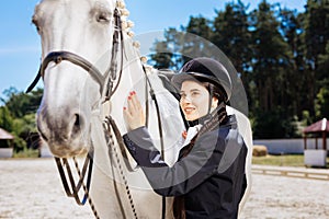Beautiful woman with red nail art fond of equestrianism