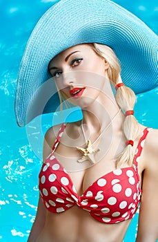 Beautiful woman in red polka dots fashionable swimsuit. PinUp