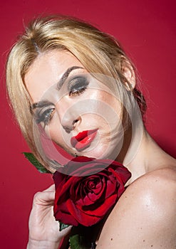 Beautiful woman with red rose flower. Pink lips and rose. Beauty girl. Sensual sexy mouth. Nofilter unaltered skin.