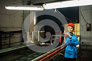 Beautiful woman in red safety helmet work as industrial worker