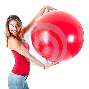 Beautiful woman with red shirt holding a mega balloon