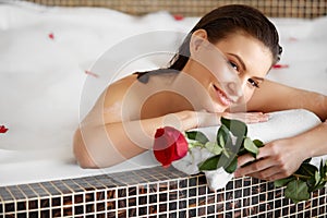 Beautiful Woman Relaxing in Bath With Rose. Body Care