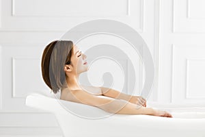 Beautiful woman relaxing in bathtub