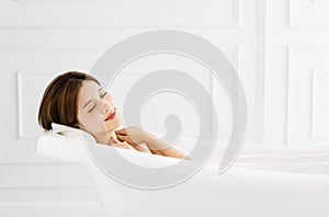 Beautiful woman relaxing in bathtub