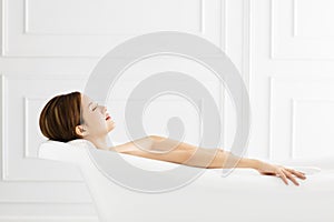 Beautiful woman relaxing in bathtub