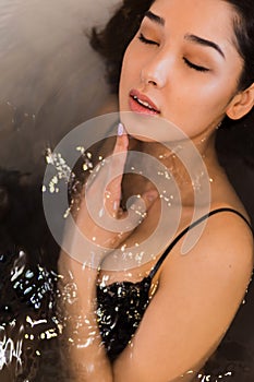 Beautiful woman relaxing in bathtub. Therapeutic bath,