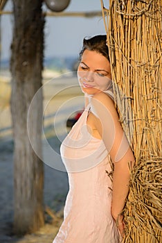 Beautiful woman relaxing on the beach on sunset
