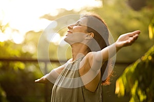 Beautiful woman relaxing and feeling nature at park