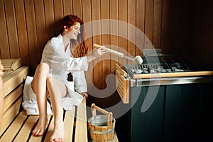 Beautiful woman relaxing in finnish sauna