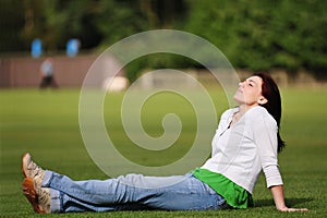 Beautiful Woman Relaxing on the Grass