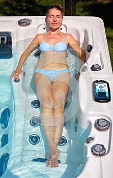 Beautiful woman relaxing in hot tub.