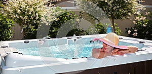 Beautiful woman relaxing in hot tub. photo