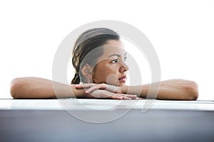 Beautiful woman is relaxing in an infinity pool