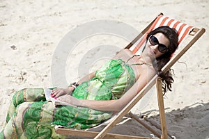 Beautiful woman relaxing lying on a sun lounger