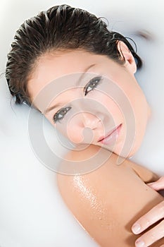 Beautiful woman relaxing in milk bath