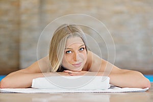 Beautiful woman relaxing in spa salon with hot stones on body. Beauty treatment therapy