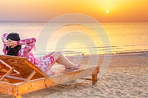 Beautiful woman relaxing at sunrise over Red Sea